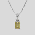 This white gold Fancy Yellow Emerald Solitaire Diamond Necklace made with an fancy yellow emerald cut diamond in a four prong setting with adjustable chain 