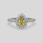 This video features a white gold Pear Diamond Halo Engagement Ring is made with a fancy yellow pear solitaire diamond set in a four-prong setting