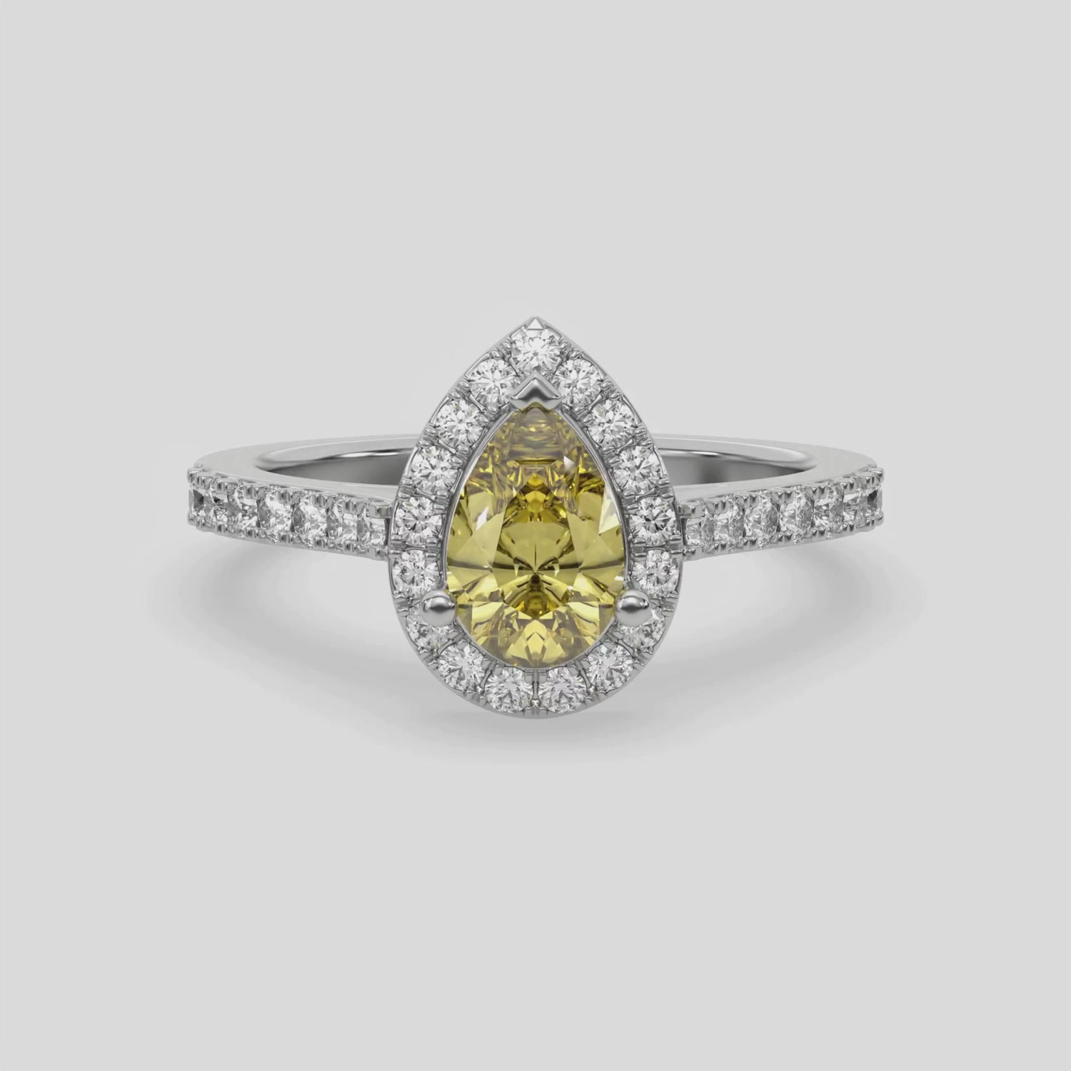 This video features a white gold Pear Diamond Halo Engagement Ring is made with a fancy yellow pear solitaire diamond set in a four-prong setting