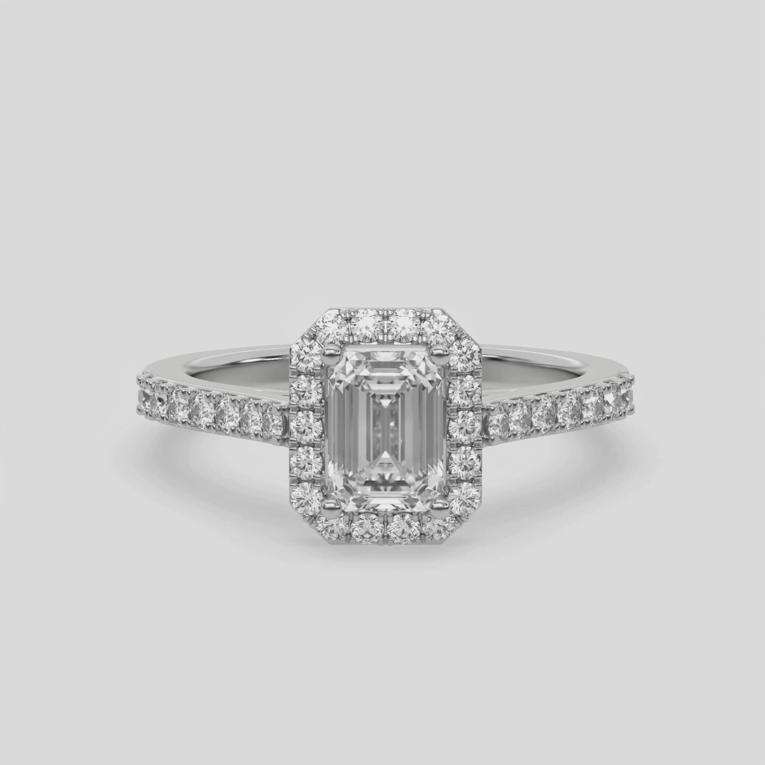 This video features a white gold Emerald Diamond Halo Engagement Ring is made with an emerald solitaire diamond set in a four-prong setting 