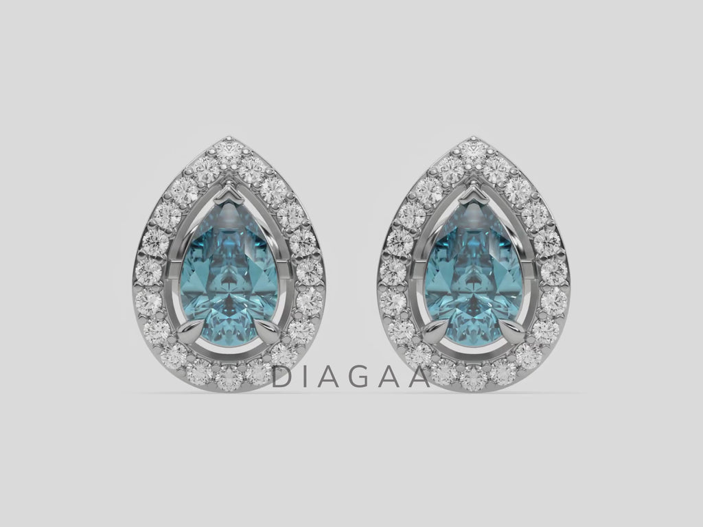 18k white gold Pear Diamond Halo Earrings made with a fancy Blue pear cut solitaire diamonds set in a four prong setting.