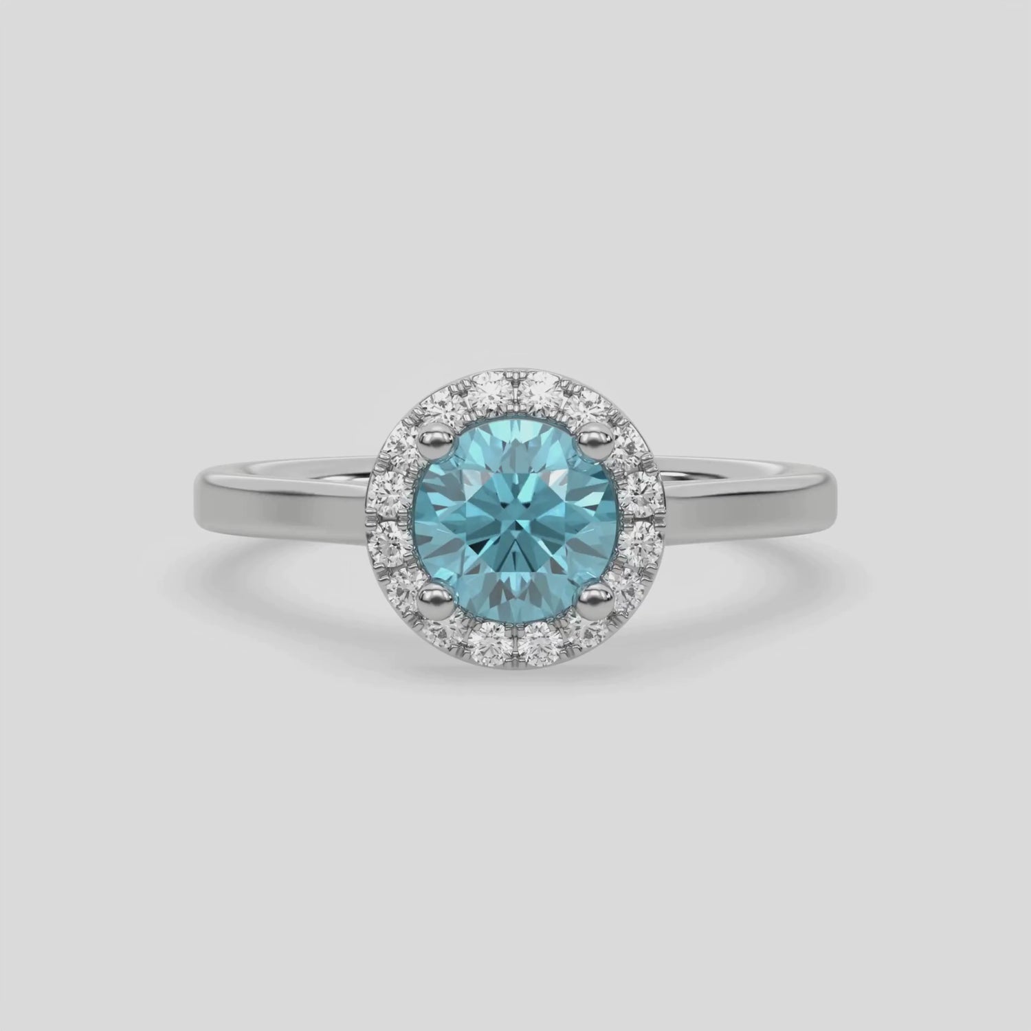 This video features a white gold ring features a fancy Blue round solitaire diamond set in a four-prong setting