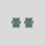 This video features a white gold Classic Emerald Diamond Earrings made with an fancy green emerald-cut diamonds set in a four prong setting