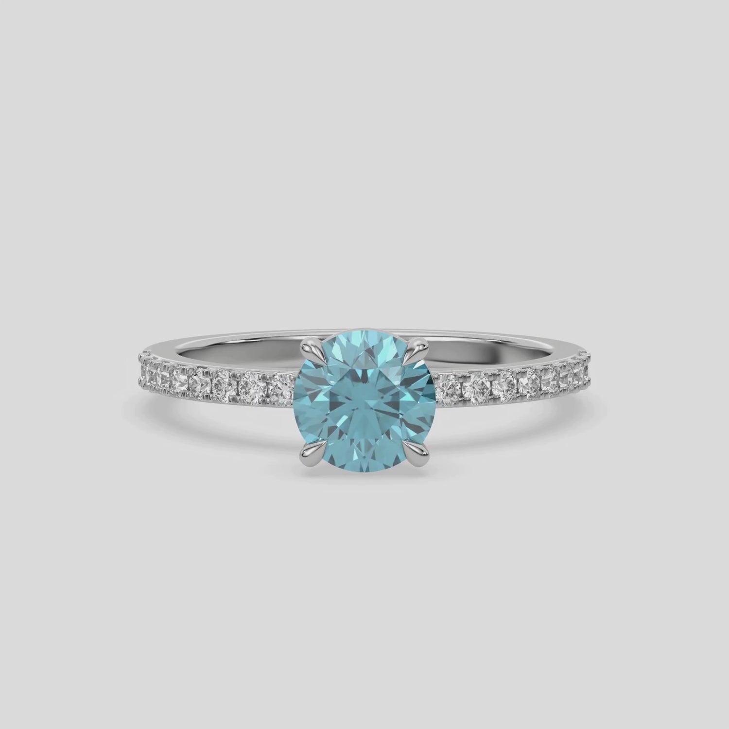 This video features a white gold ring is made with a fancy Blue round solitaire diamond set in four-prong setting