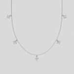 Round Dangling Diamond Necklace made with five round brilliant-cut diamonds each set in a prong setting, distributed evenly along the chain