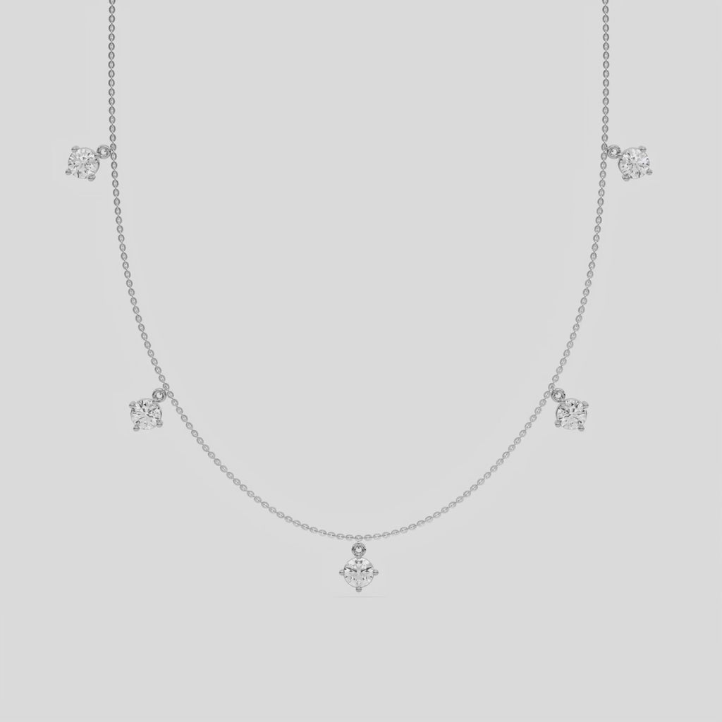 Round Dangling Diamond Necklace made with five round brilliant-cut diamonds each set in a prong setting, distributed evenly along the chain