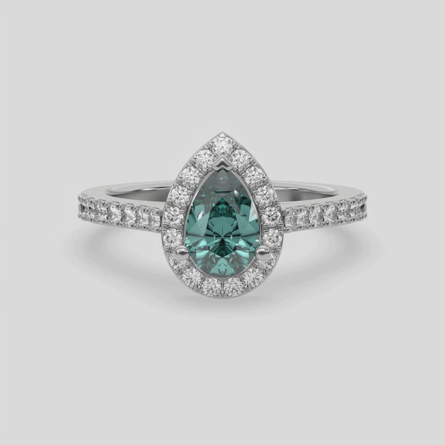 This video features a white gold Pear Diamond Halo Engagement Ring is made with a fancy green pear solitaire diamond set in a four-prong setting