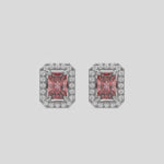 This video features a white gold Classic Radiant Diamond Halo Earrings made with a fancy pink radiant cut solitaire diamonds set in a four prong setting