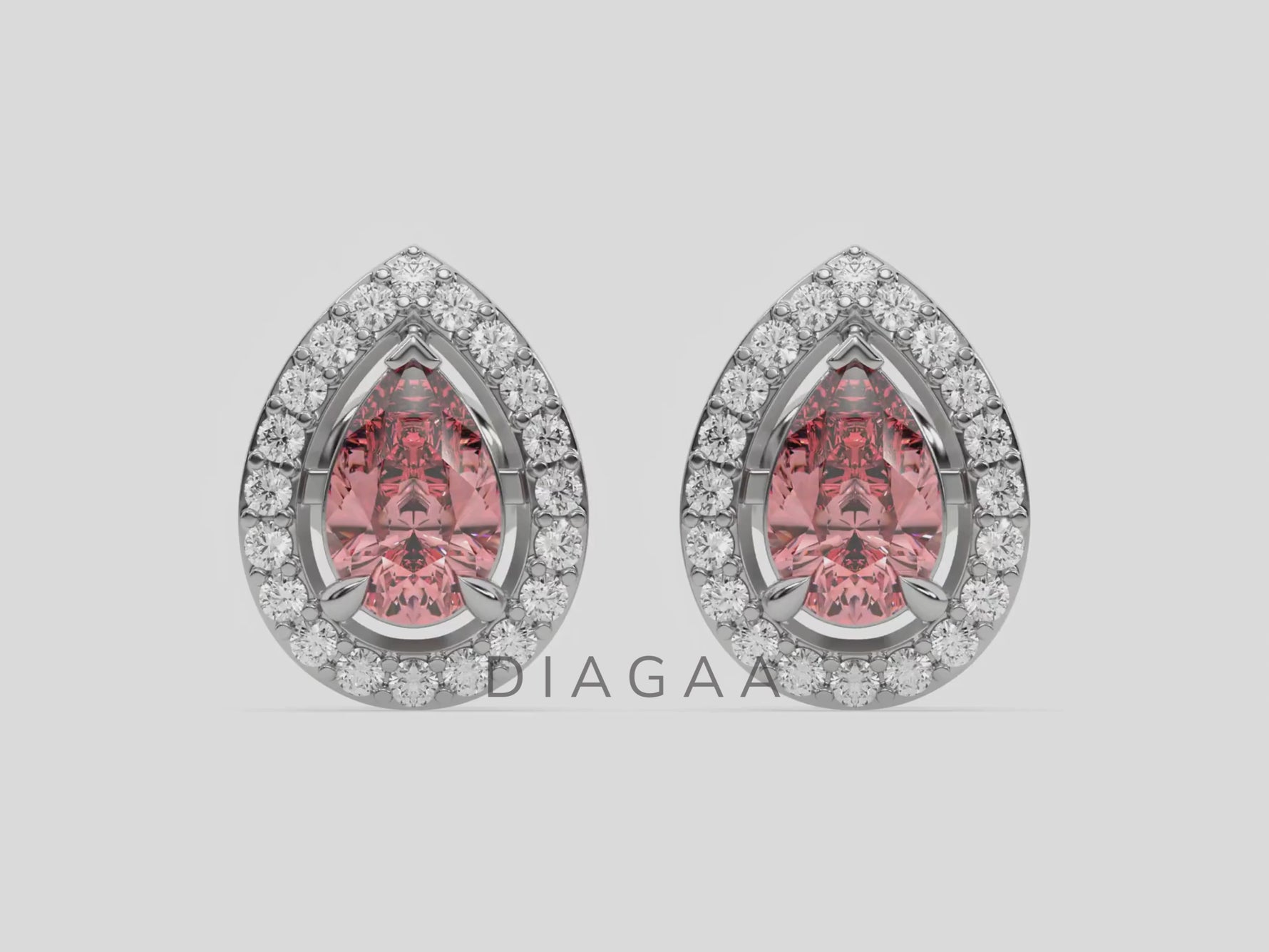 18k white gold Pear Diamond Halo Earrings made with a fancy pink pear cut solitaire diamonds set in a four prong setting.