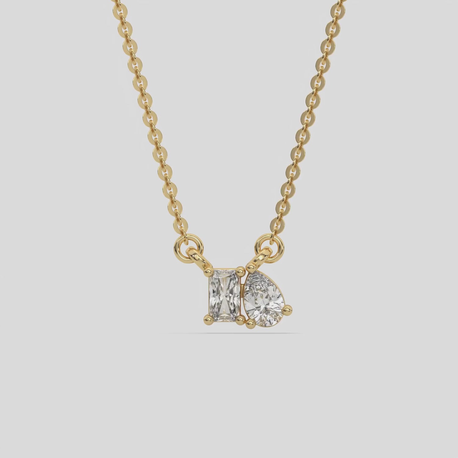 This yellow gold Cluster Diamond Necklace made with radiant and pear diamonds, positioned right next to each other and securely set in prong setting 