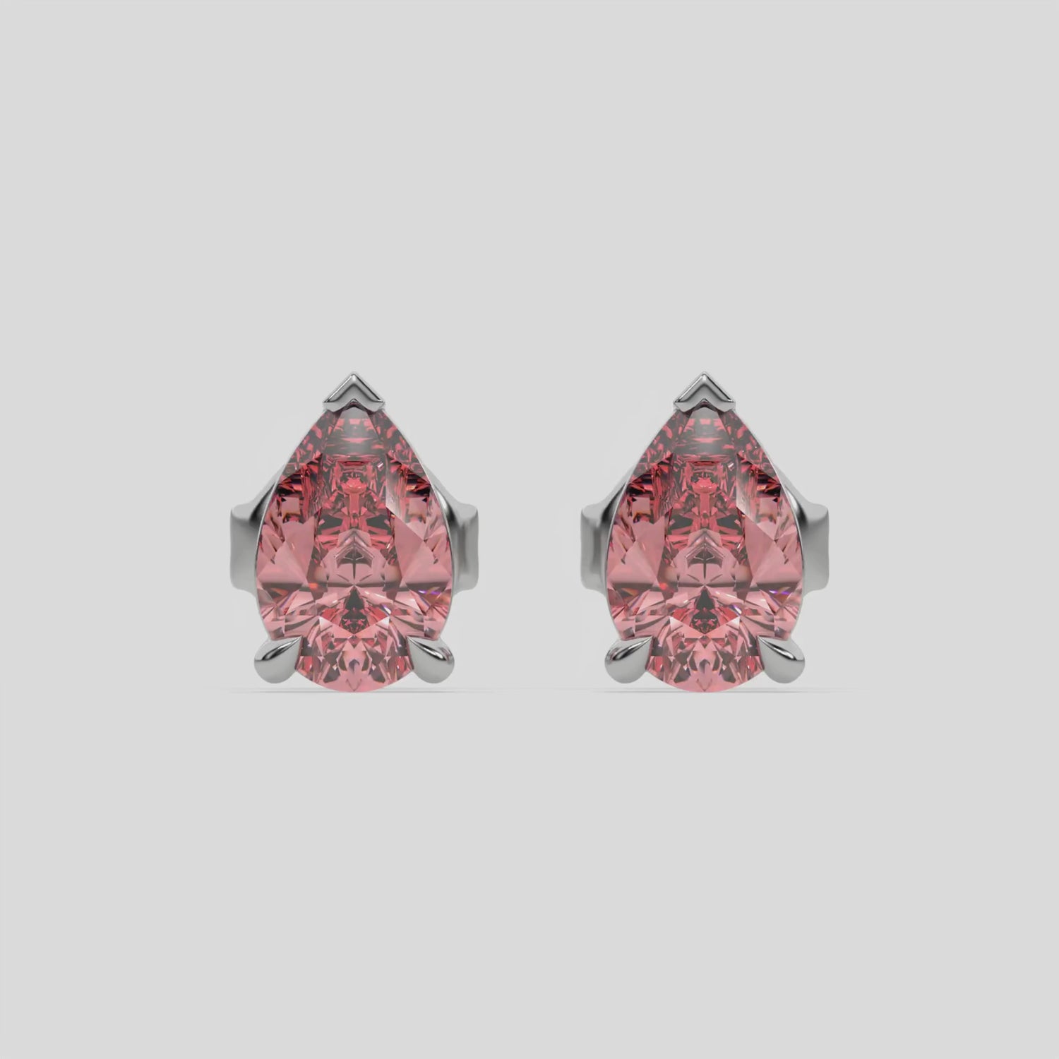 This video features a white gold Classic Pear Diamond Earrings made with a fancy pink pear-cut diamonds set in a four prong setting