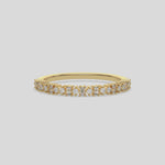 This yellow gold ring displayed on front view is made with brilliant round diamond and baguette diamond set in prong setting