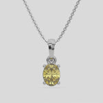 This white gold Fancy Yellow Oval Solitaire Diamond Necklace made with an fancy yellow oval cut diamond in a four prong setting with adjustable chain 