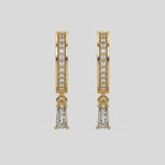 This video features a yellow gold Dangling Baguette Diamond Hoop Earrings handmade with round brilliant-cut diamonds in pave setting and a baguette solitaire hanging at the bottom