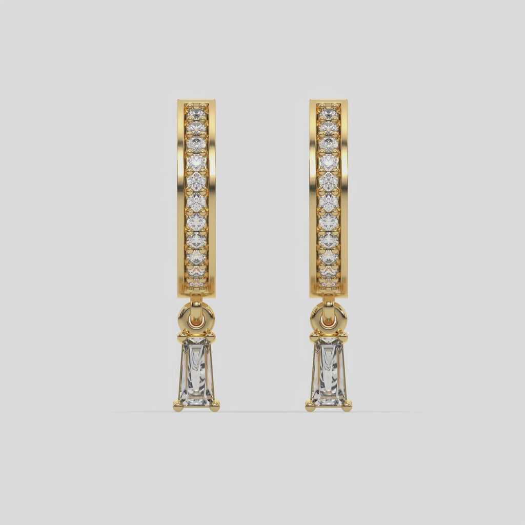 This video features a yellow gold Dangling Baguette Diamond Hoop Earrings handmade with round brilliant-cut diamonds in pave setting and a baguette solitaire hanging at the bottom