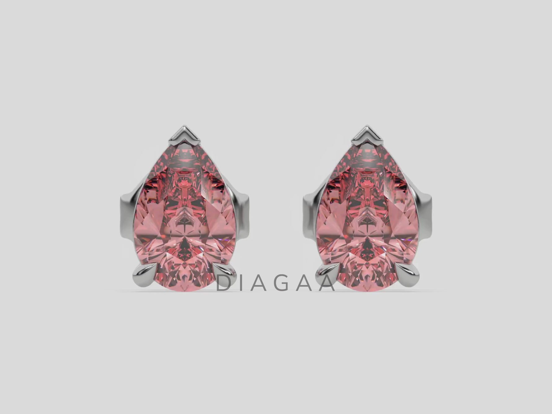 18k white gold Pear shaped diamond stud earrings made with a fancy pink pear shaped diamond set in a four prong setting