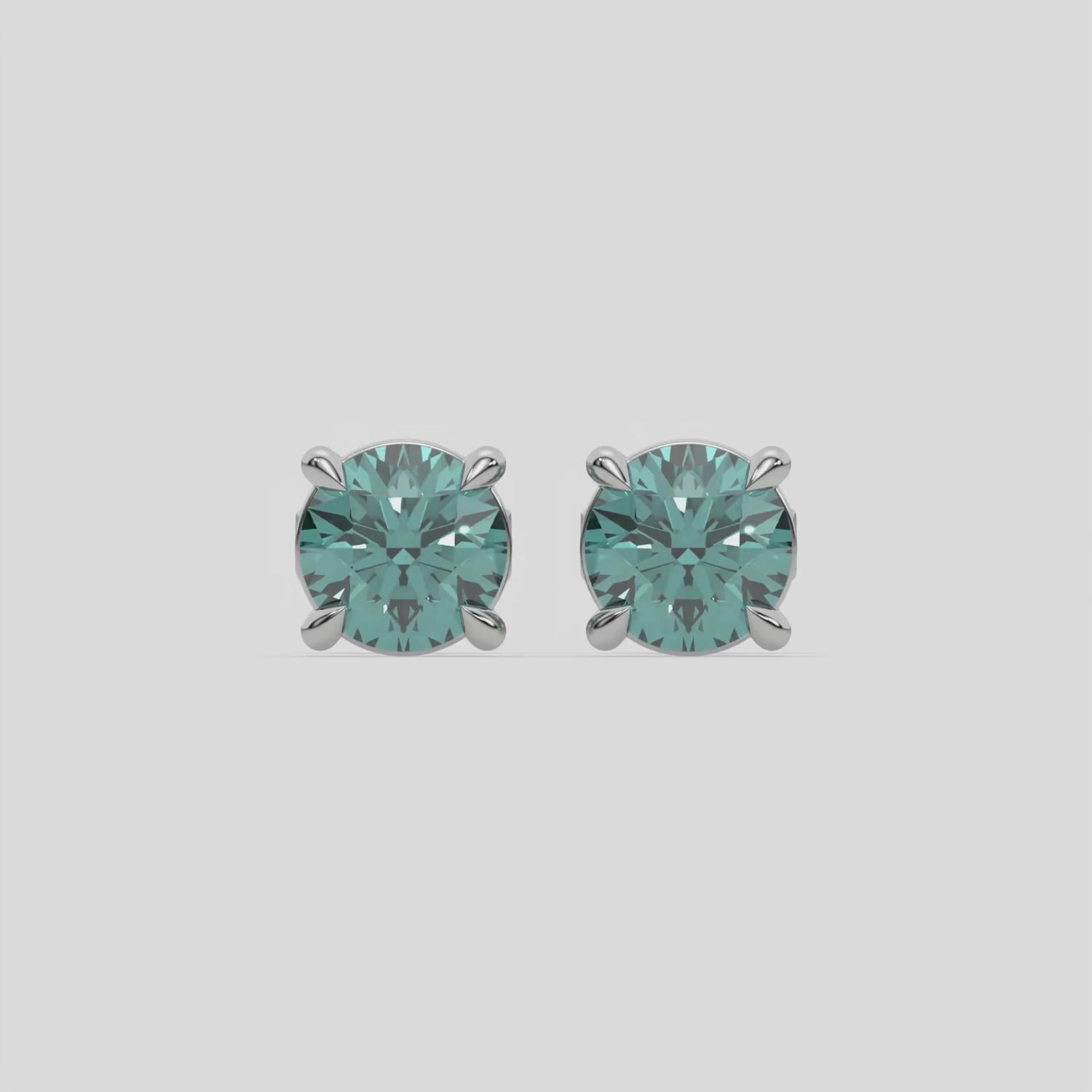 This video features a white gold Classic Round Diamond Studs made with fancy green round brilliant-cut diamonds set in a four prong setting