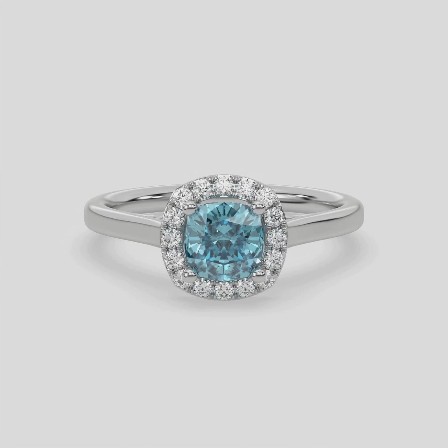 This video features a white gold ring features a fancy Blue cushion solitaire diamond set in a four-prong setting