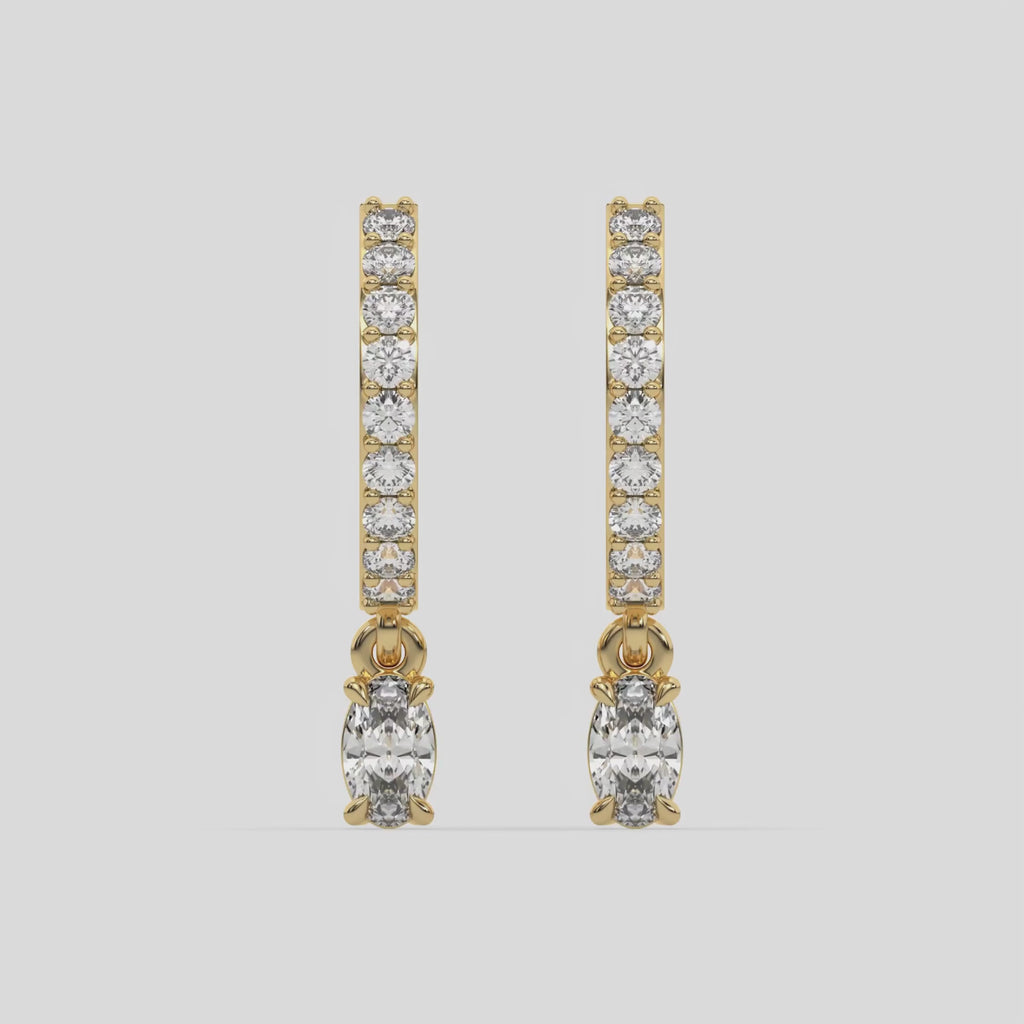 This video features a yellow gold Dangling Oval Diamond Hoop Earrings handmade with round brilliant-cut diamonds in prong setting and an oval solitaire hanging at the bottom