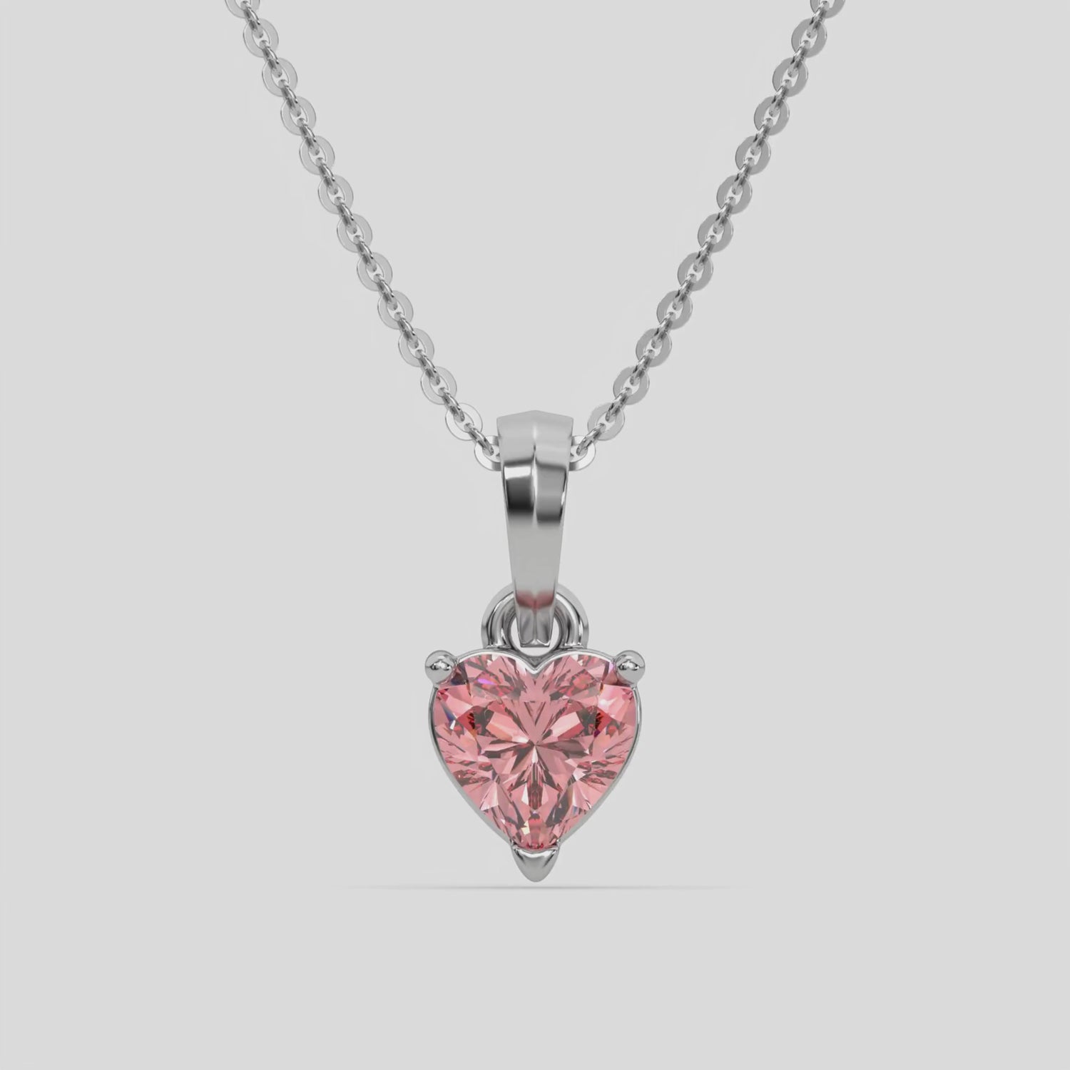 This white gold Fancy Pink Heart Solitaire Diamond Necklace made with a fancy Pink heart cut diamond in a four prong setting with adjustable chain 