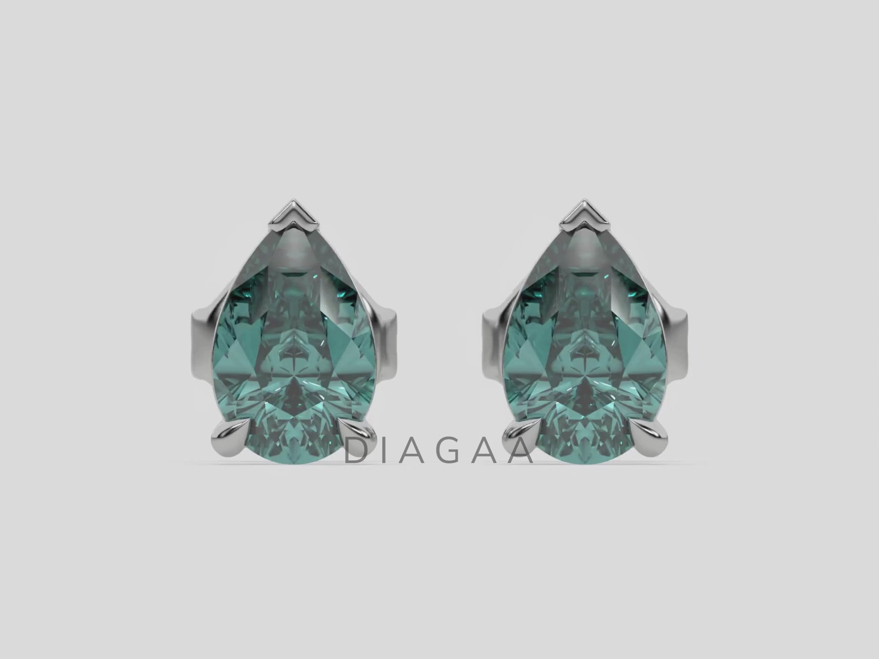 18k white gold Pear shaped diamond Earrings made with a fancy green pear shaped diamond set in a four prong setting