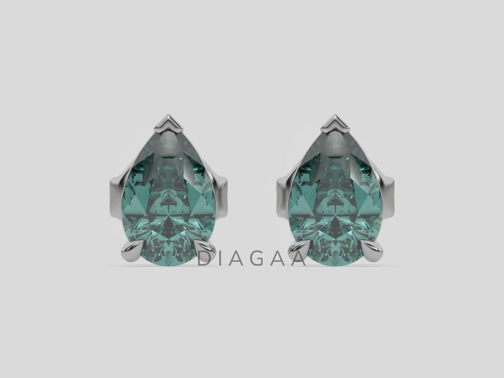 18k white gold Pear shaped diamond Earrings made with a fancy green pear shaped diamond set in a four prong setting