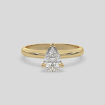 This video features a yellow gold ring features a pear solitaire diamond elegantly secured in a three-prong setting on a solid gold band 