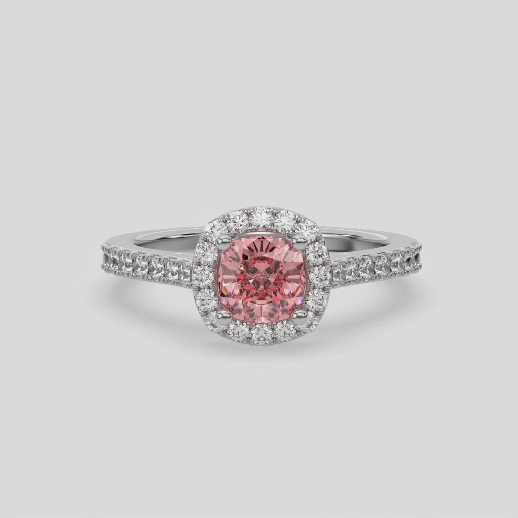 This video features a white gold Cushion Diamond Halo Engagement Ring is made with a fancy Pink cushion solitaire diamond set in a four-prong setting