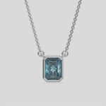 This white gold Fancy Blue Radiant Solitaire Diamond Necklace made with a fancy Blue radiant cut diamond in bezel setting with adjustable chain 