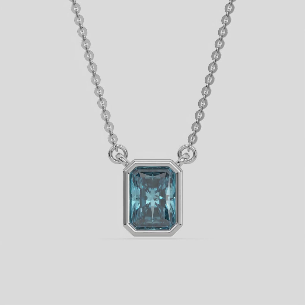 This white gold Fancy Blue Radiant Solitaire Diamond Necklace made with a fancy Blue radiant cut diamond in bezel setting with adjustable chain 