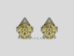 18k white gold Pear shaped diamond Earrings made with a fancy yellow pear shaped diamond set in a four prong setting
