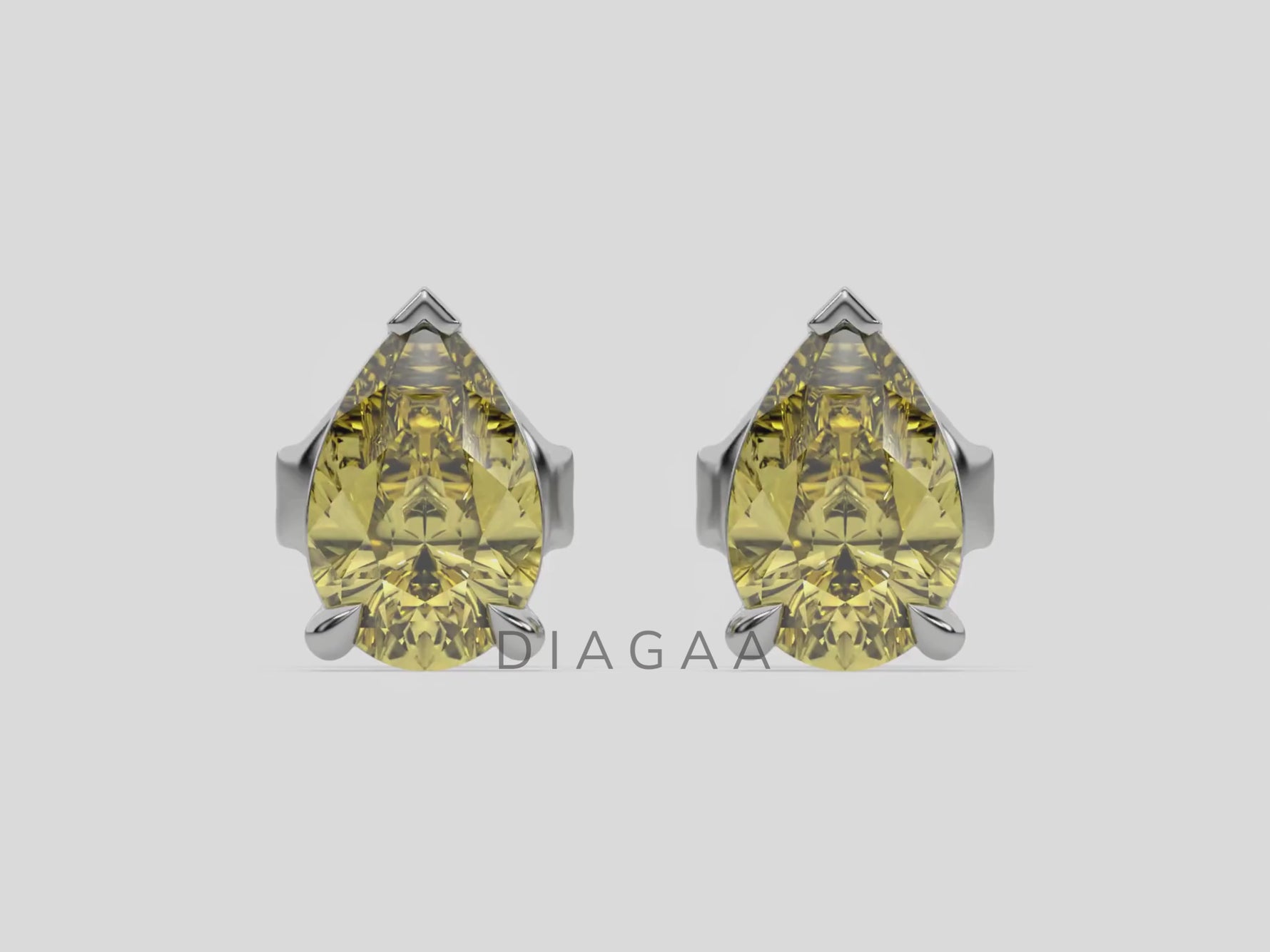 18k white gold Pear shaped diamond Earrings made with a fancy yellow pear shaped diamond set in a four prong setting