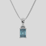 Fancy Blue Radiant Solitaire Diamond Necklace made with fancy radiant cut diamond in a four prong setting with adjustable chain