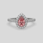 This video features a white gold Pear Diamond Halo Engagement Ring is made with a fancy pink pear solitaire diamond set in a four-prong setting