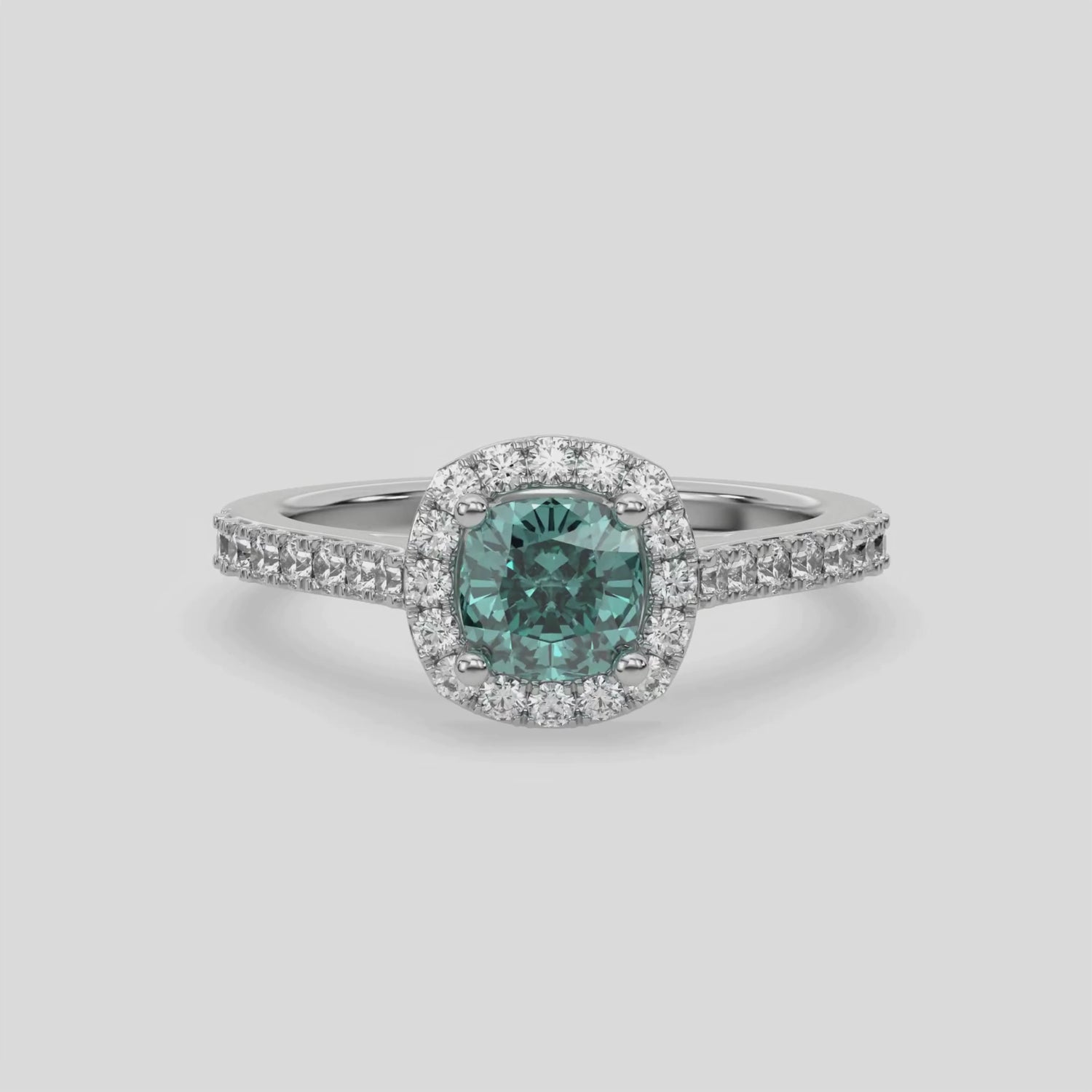 This video features a white gold Cushion Diamond Halo Engagement Ring is made with a fancy green cushion solitaire diamond set in a four-prong setting