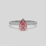 This video features a white gold ring is made with a fancy Pink pear solitaire diamond set in three-prong setting, and is complemented by a round pave diamonds band