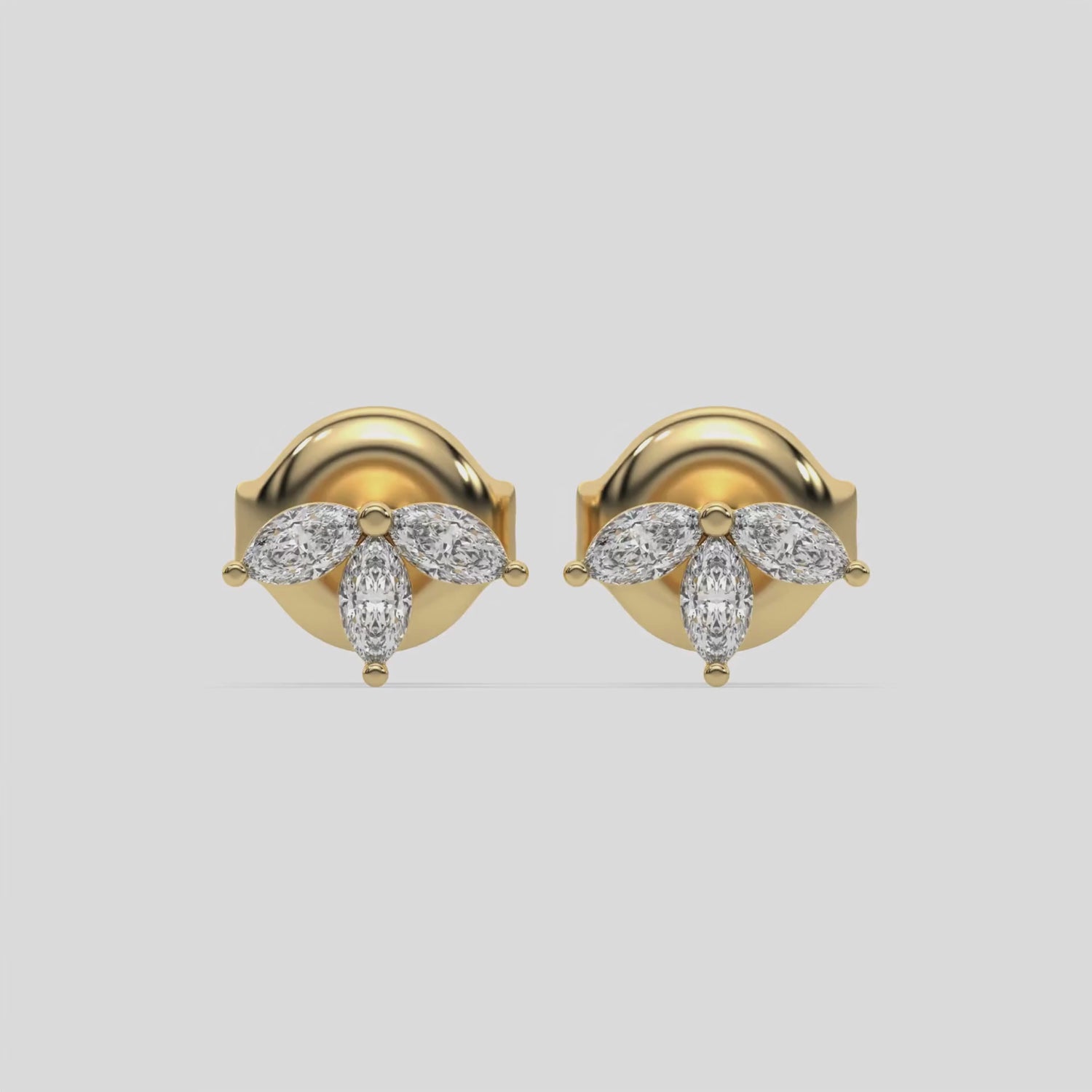 This video features a yellow gold Marquise Crown Earrings made with three marquise diamonds and arranged to form a crown-like shape, securely set in prong setting