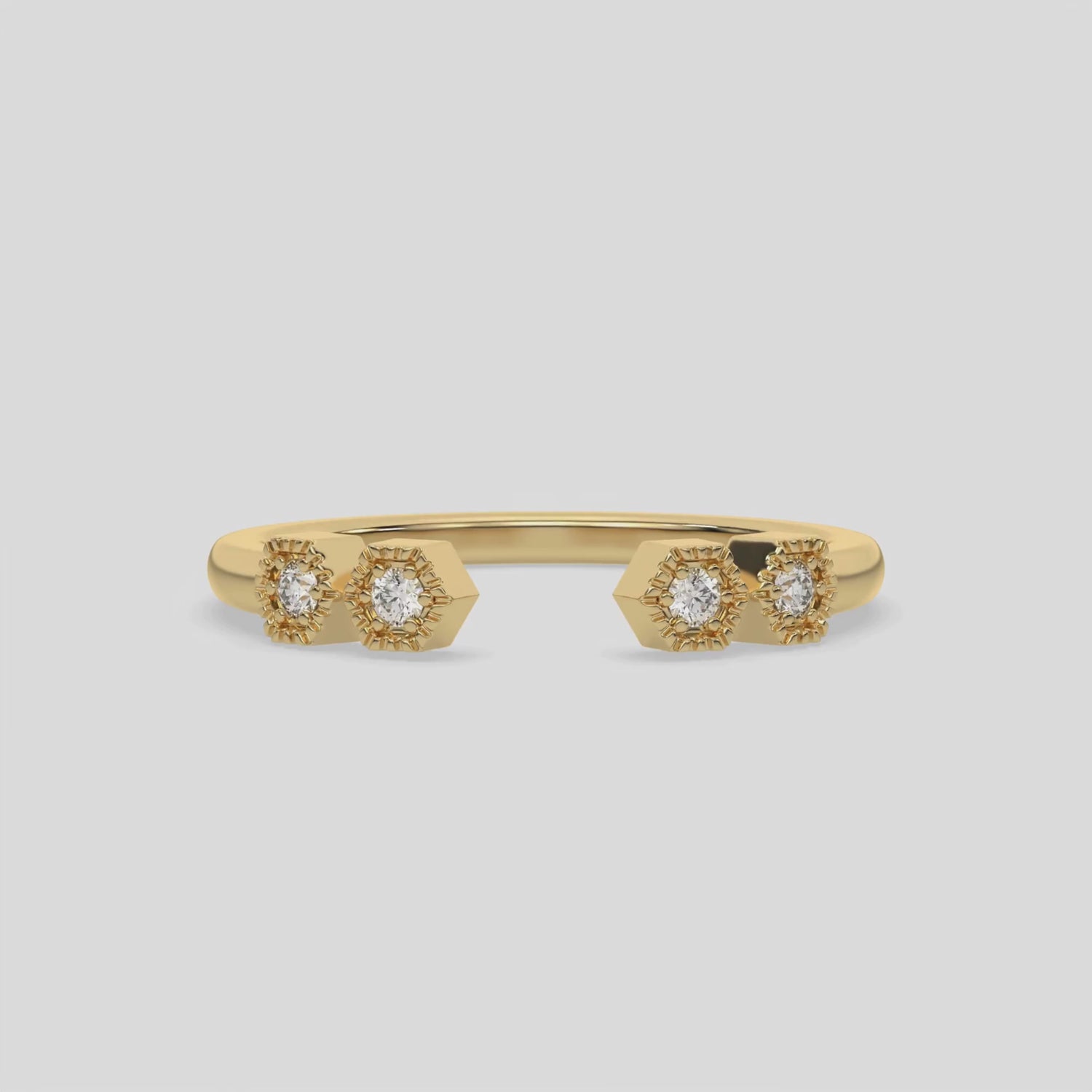 This video features a yellow gold Open Diamond Ring is handmade with round brilliant-cut diamonds with a gap in the middle. Each diamond is set in an hexagonal bezel with milgrain detailing on top