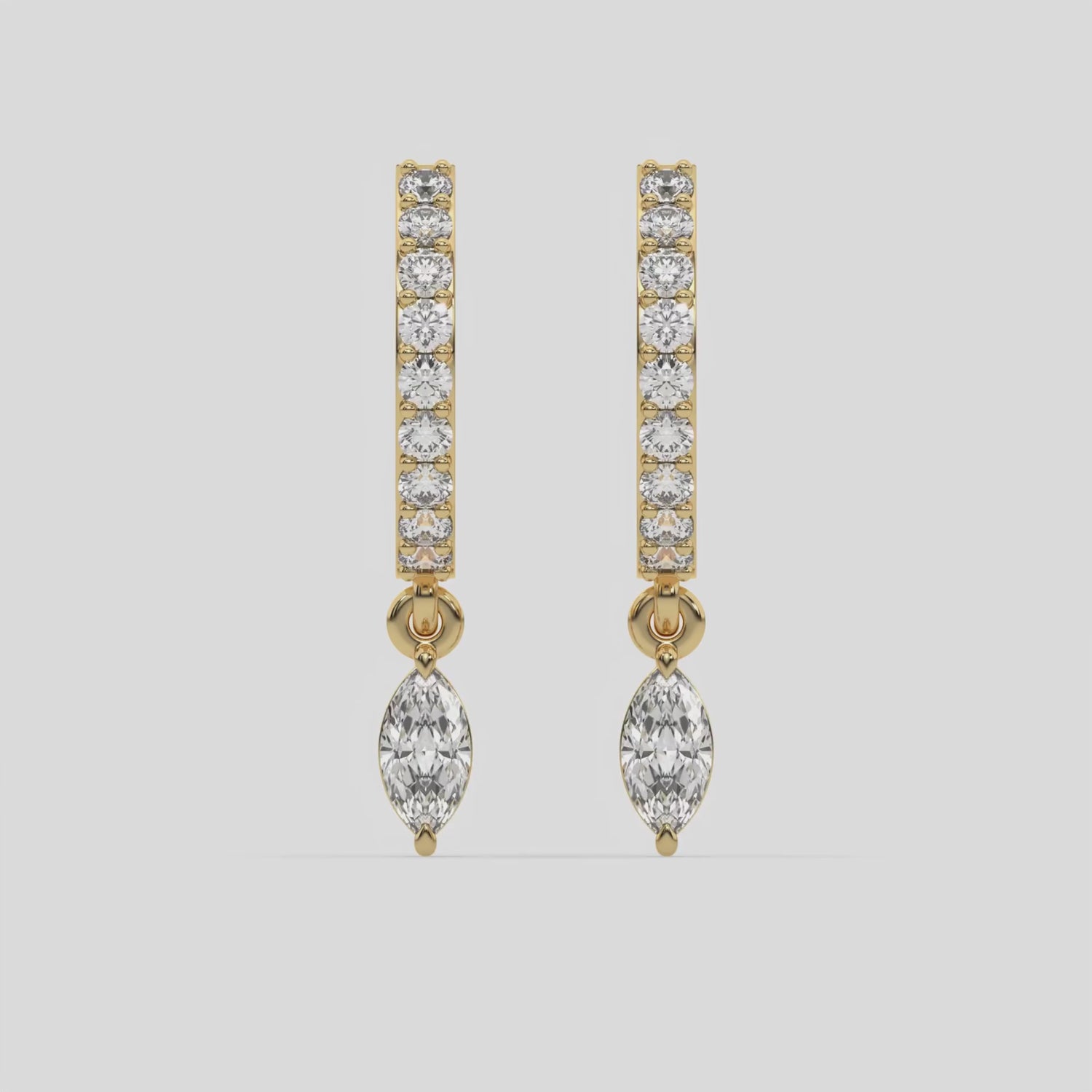 This video features a yellow gold Dangling Marquise Diamond Hoop Earrings handmade with round brilliant-cut diamonds in prong setting and a marquise solitaire hanging at the bottom