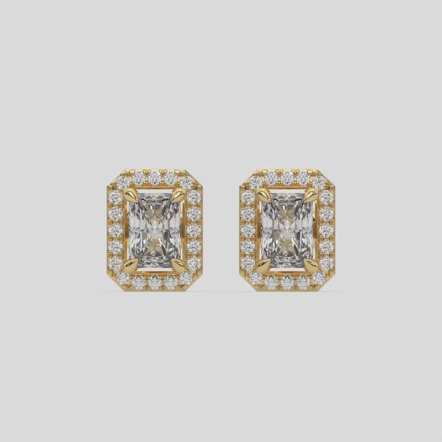 This video features a yellow gold Classic Radiant Diamond Halo Earrings made with a radiant-cut solitaire diamonds set in a four prong setting