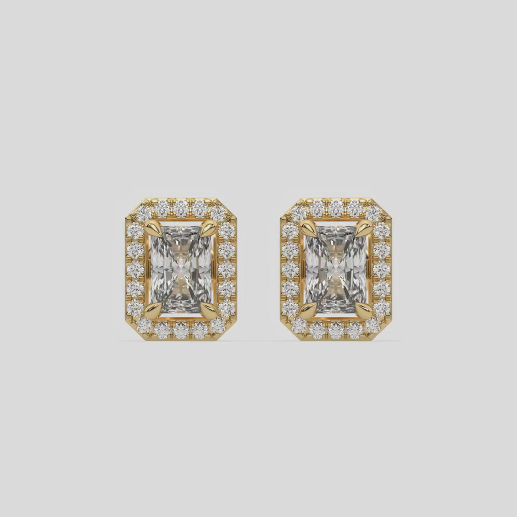 This video features a yellow gold Classic Radiant Diamond Halo Earrings made with a radiant-cut solitaire diamonds set in a four prong setting