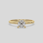 This video features a yellow gold ring features a cushion solitaire diamond elegantly secured in a four-prong setting on a solid gold band 