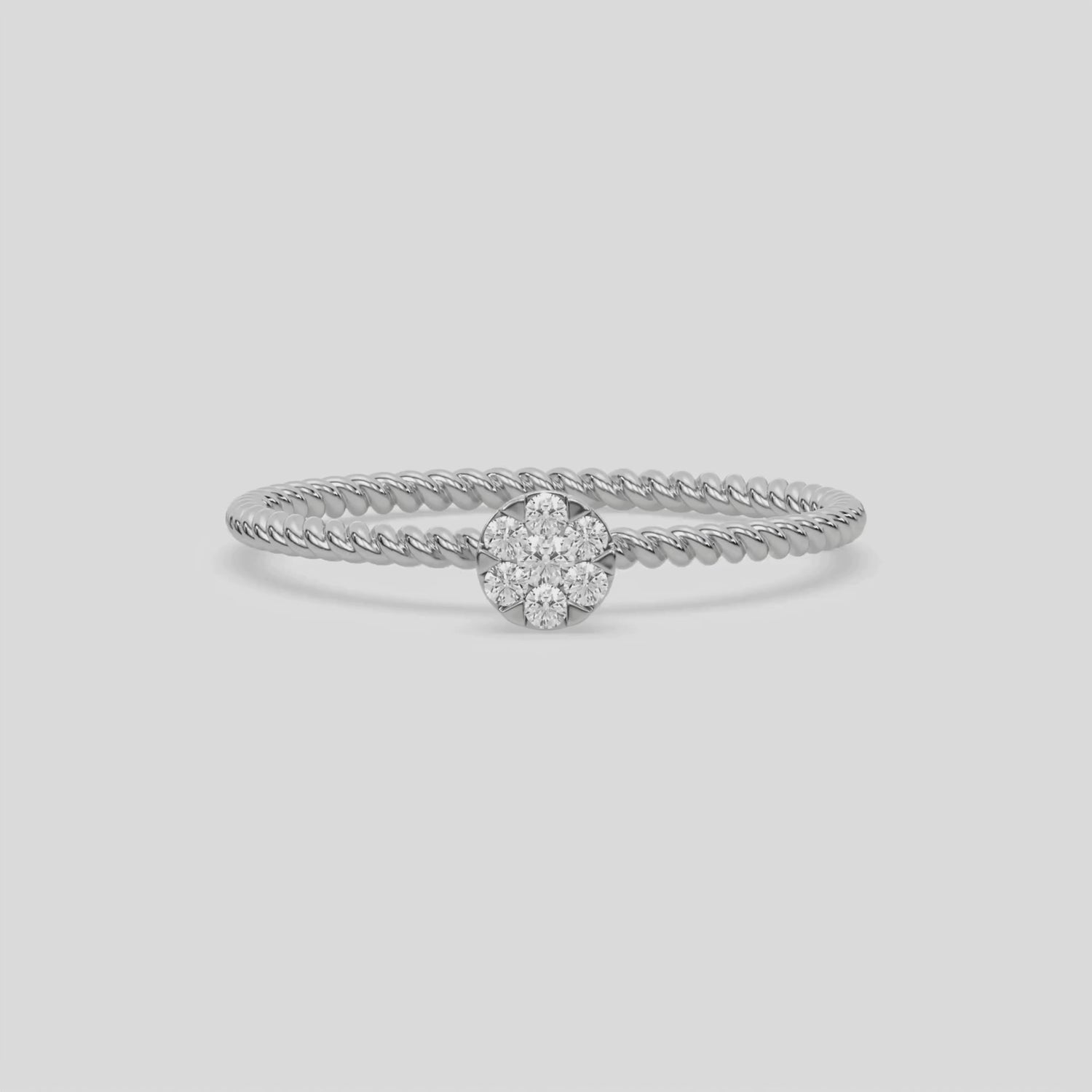 This video features a white Thin gold twisted rope band with a solitaire made with round diamonds in a cluster setting