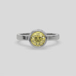 This yellow gold ring displayed on front view is made with brilliant round solitaire diamond set in bezel setting