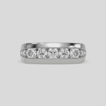 This video features a white gold Men's channel-set diamond ring seamlessly blends solid gold with round brilliant-cut diamonds. The diamonds are expertly placed in a channel setting  