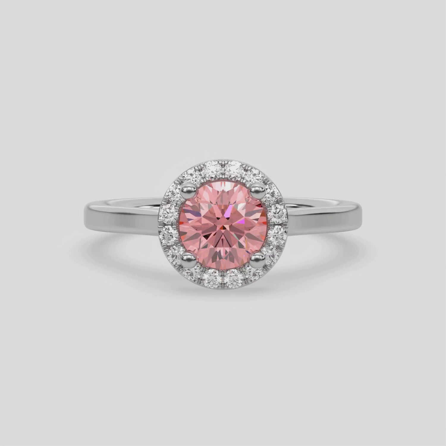 This video features a white gold ring features a fancy Pink round solitaire diamond set in a four-prong setting