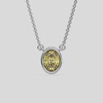 This white gold Fancy Yellow Oval Solitaire Diamond Necklace made with an fancy yellow oval cut diamond in bezel setting with adjustable chain