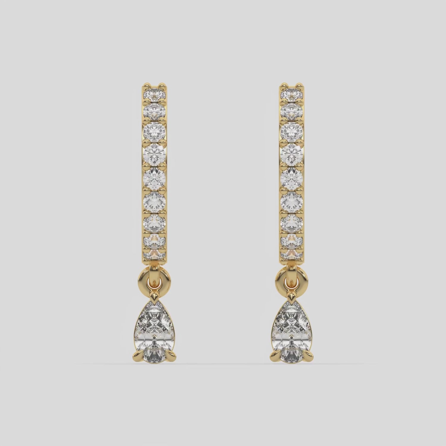 This video features a yellow gold Dangling Pear Diamond Hoop Earrings handmade with round brilliant-cut diamonds in prong setting and a pear solitaire hanging at the bottom