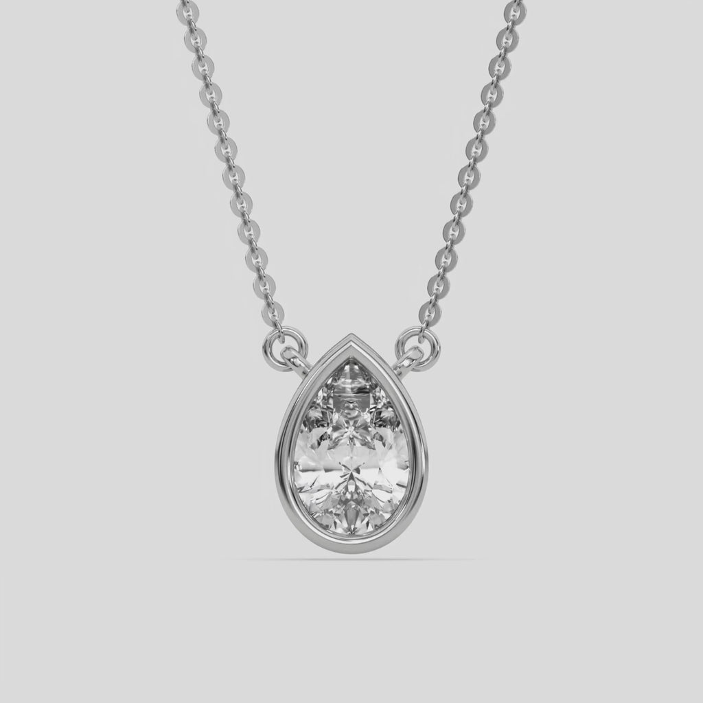  Pear Solitaire Diamond Necklace made with a pear cut diamond in bezel setting with adjustable chain 