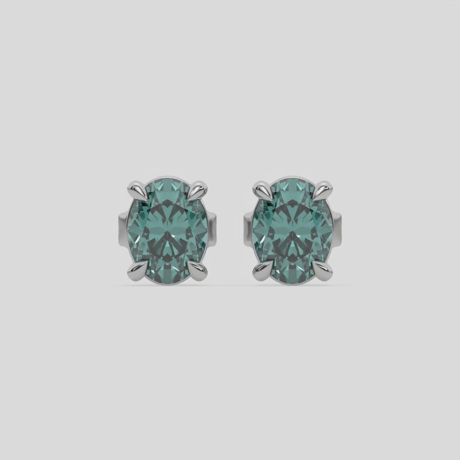 This video features a white gold Classic Oval Diamond Earrings made with an fancy green oval-cut diamonds set in a four prong setting